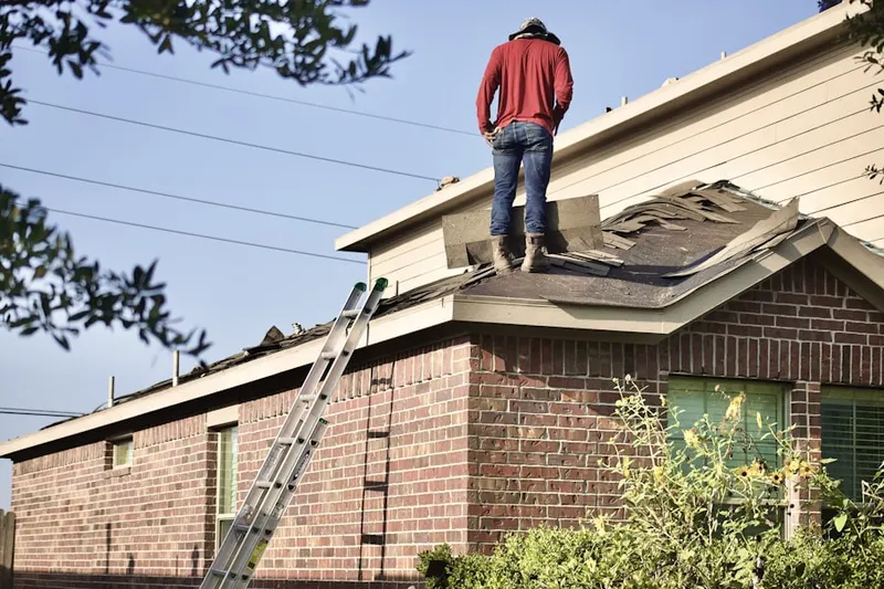 Professional roofer working on a residential roof in Fallen Leaf